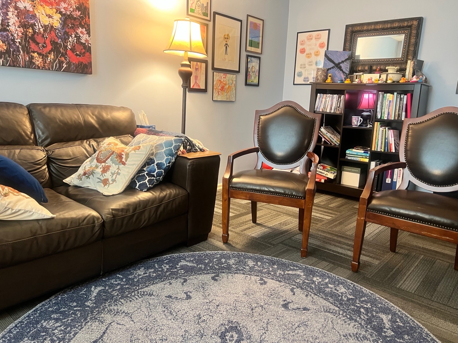 Wicker chairs and a blue rug in Cynthia Benedict's Longwood counseling office waiting area