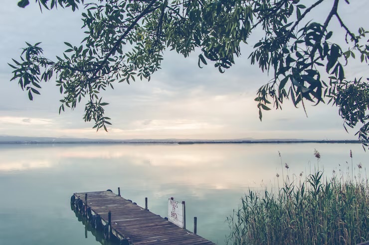 Calm lake with a wooden dock, symbolizing peace and healing through grief counseling in Longwood FL